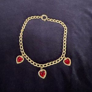 Brushed gold toned collar necklace with heart pendants